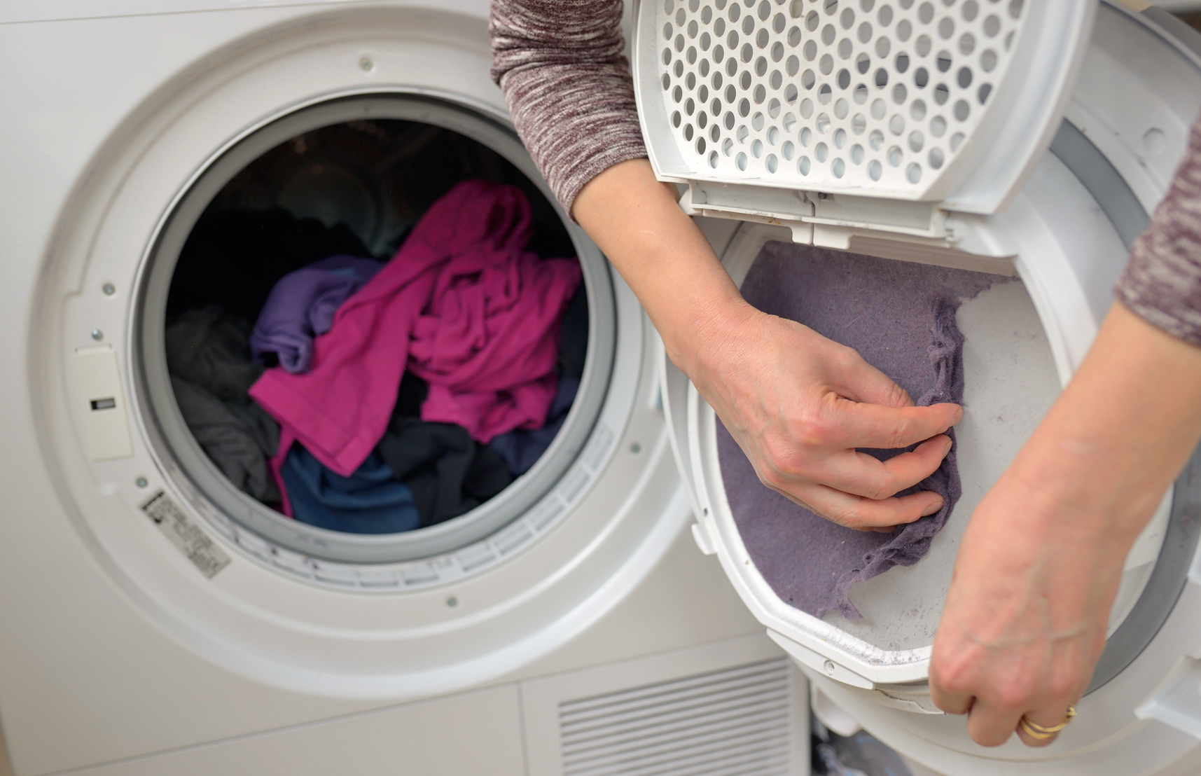Woman Taking the lint of Dryer
